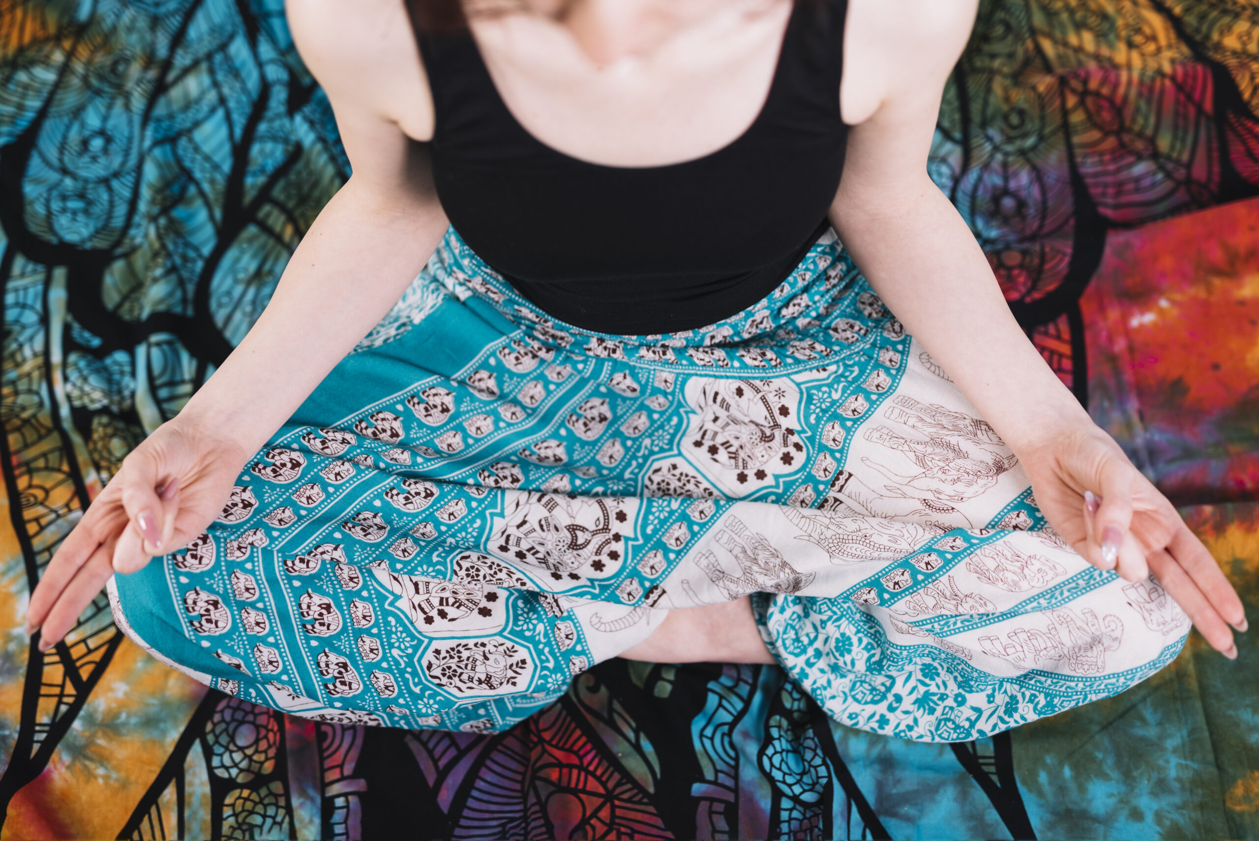 low-section-woman-sitting-lotus-pose-with-mudra-gesture-blanket